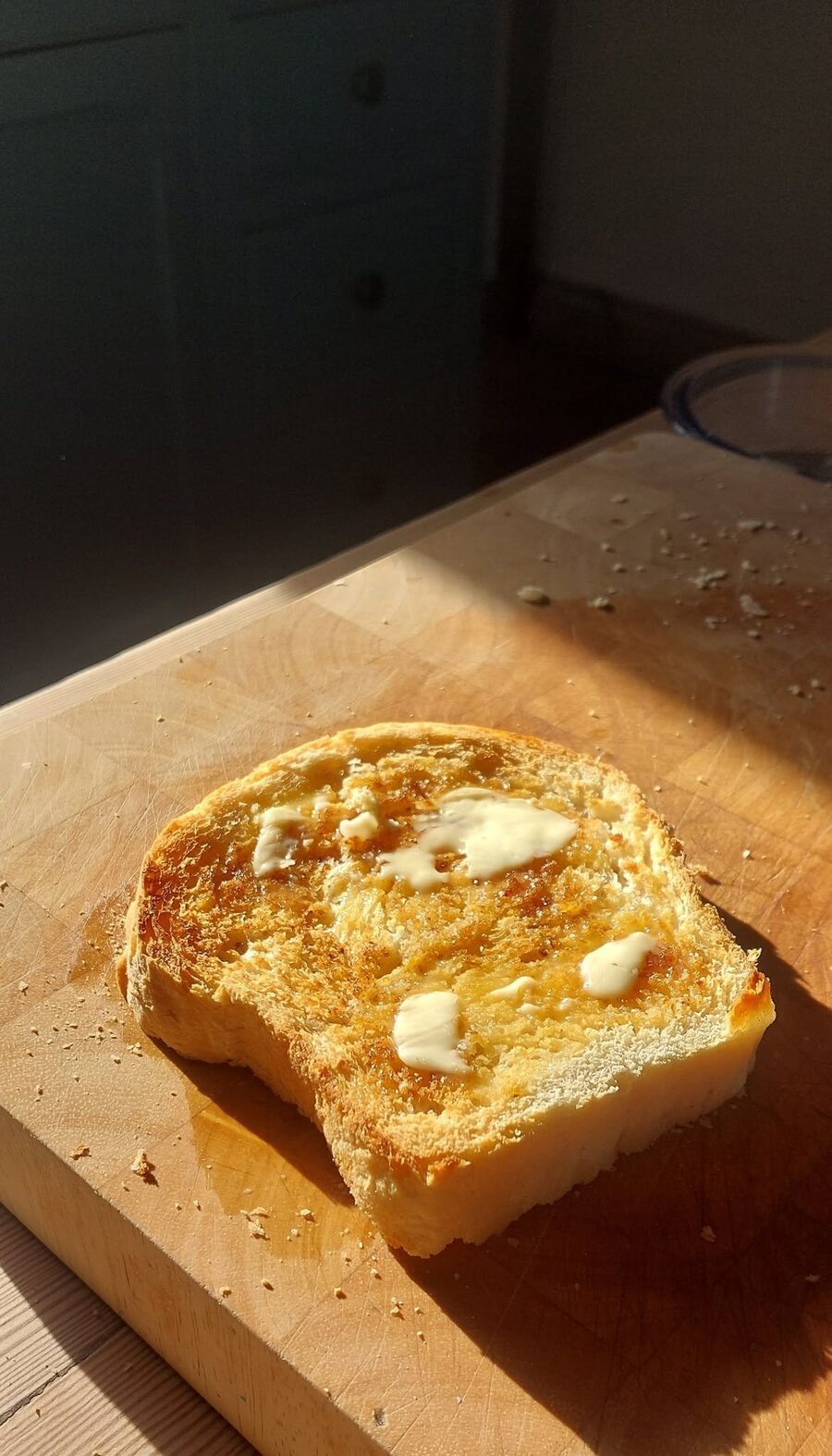 A slice of buttered toast in the morning sun